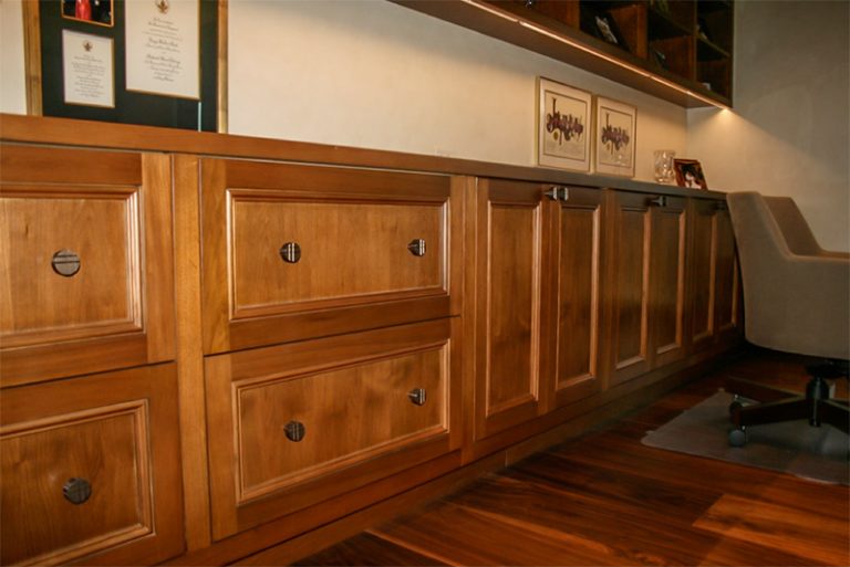 Wall of paneled cabinetry with drawers