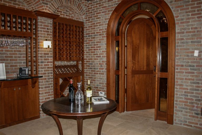 Wine cellar with an arched door and wood racking